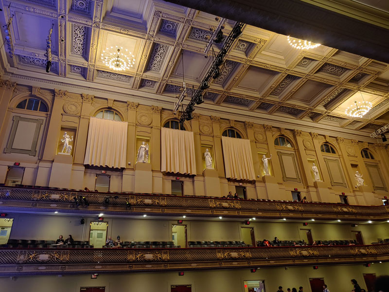 A view of the inside of Symphony Hall, adorned with statues