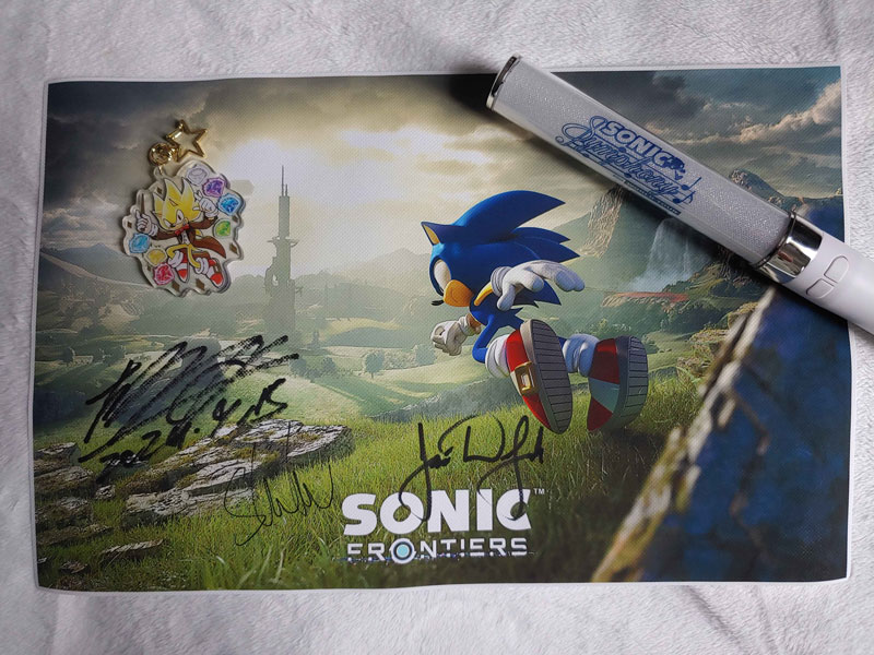 Sonic Frontiers poster with autographs from Tomoya Ohtani, Shota Nakama and Jose Delgado (orchestra conductor)